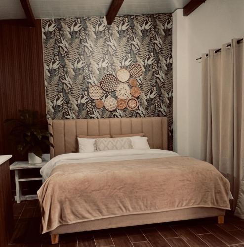 a bedroom with a large bed with a floral wallpaper at Casa Amanecer in Tonosí