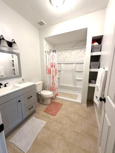 a bathroom with a sink and a toilet and a shower at Driftwood Getaway Vacation home in Fort Myers Beach