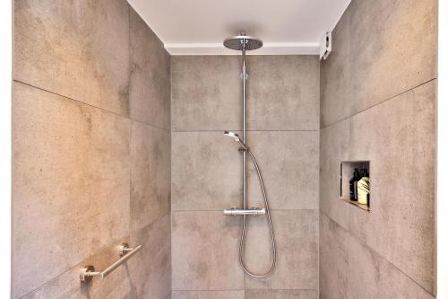 a shower with a shower head in a bathroom at Appartement im Weiherhaus in Forchheim