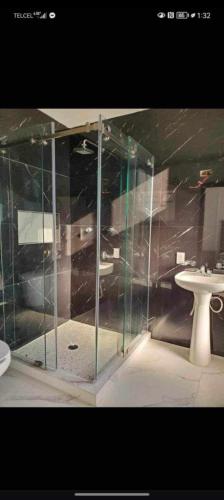 a glass shower in a bathroom with a sink at Gemela1 in Puerto Peñasco