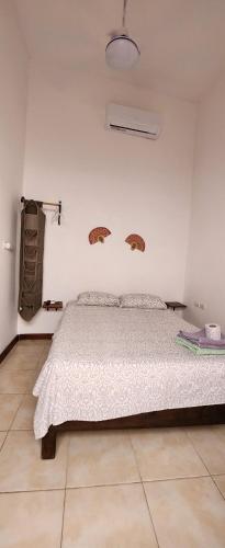 a bedroom with a large bed in a white room at Casa Rosanna in Campeche