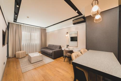 a living room with a couch and a table at SIGNUM Hotel in Podgorica