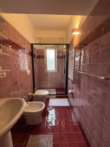 a bathroom with two toilets and a shower at Ludovica's house 2 in Giardini Naxos