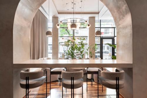 a dining room with a large table and stools at CasaSur Palermo Hotel in Buenos Aires