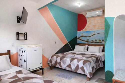 a room with two beds and a painting on the wall at Pousada Vila Formosa in Belém