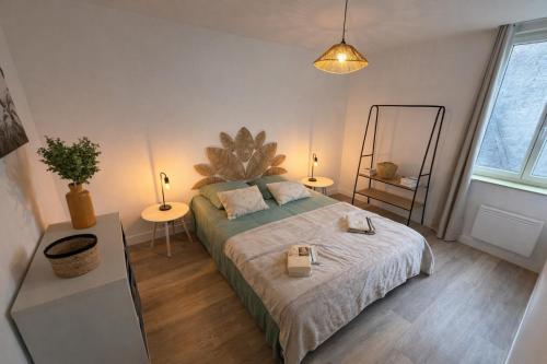 a bedroom with a bed and two tables and a mirror at Douce Escale - 1 chambre - literie premium in Calais