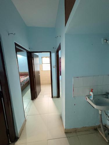 an empty bathroom with a sink and a mirror at Apna Ghar in Bhopal