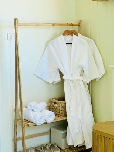 a rack with towels and a robe on it at BaanRabiangnam kohlarn in Ko Larn