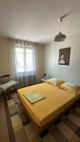 a bedroom with a large bed and a chair at Domaine du Mont des Chênes in Monthou-sur-Cher