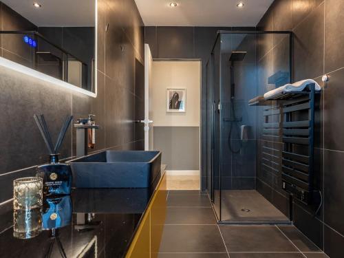 a bathroom with a blue sink and a shower at MYō in Dorno