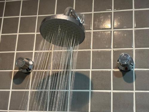 a shower with water coming out of it at Town Co - Apartment 1004 in Porto Alegre