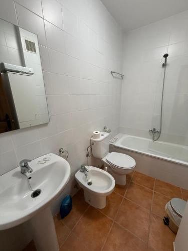 a bathroom with a sink and a toilet and a tub at Alfarnate Antiguo Cuartel in Alfarnate