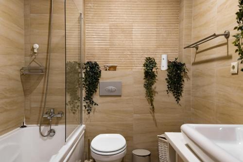 a bathroom with a toilet and a tub and a sink at Seyra Home Studio - Modern Flat Pool Free Parking Self Check-in in Ştefăneştii de Sus