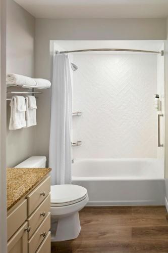 a bathroom with a tub and a toilet and a shower at TownePlace Suites Bowie Town Center in Bowie