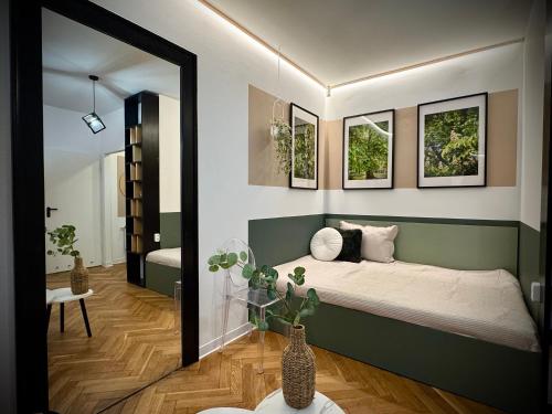 a bedroom with a large bed and a mirror at Apartamenty Młyńska 3A in Gliwice