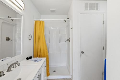a white bathroom with a shower and a sink at Tempe Resort, Pool with Diving Board, 4BR in Tempe
