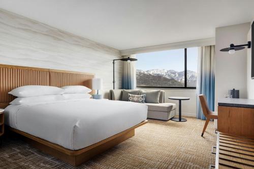 a bedroom with a large white bed and a couch at Salt Lake City Marriott University Park in Salt Lake City