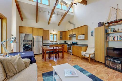 a kitchen and living room with a couch and a table at Loon's Landing in Sea Ranch