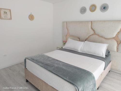 a bedroom with a large bed with a headboard at Room cerca al aeropuerto #1 in Bogotá