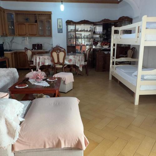 a living room with two bunk beds and a table at Orikum Holiday Apartaments in Orikum