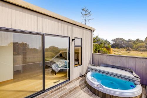a hot tub on the deck of a house at Heron's Nest in Sea Ranch