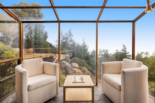 two chairs and a coffee table in a glass house at Sequoia Vista in Gualala