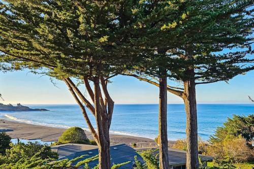 two trees in front of a beach with the ocean at Eagle's Landing - Main House & Studio in Gualala