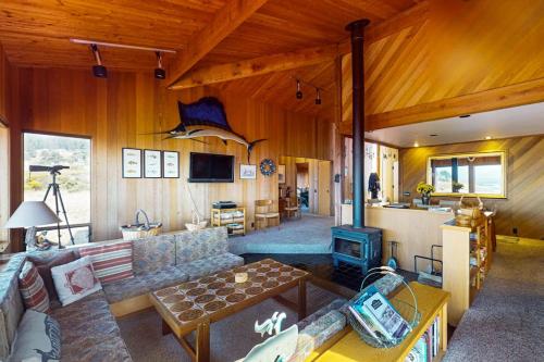 a living room with a couch and a stove at Touch the Tides in Sea Ranch