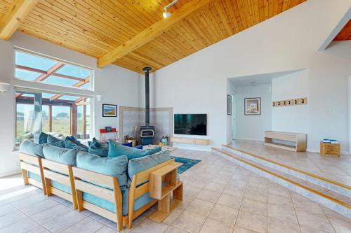 a large living room with a couch and a tv at Elizabeth Dane in Sea Ranch