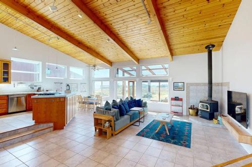 a large living room with a couch and a stove at Elizabeth Dane in Sea Ranch
