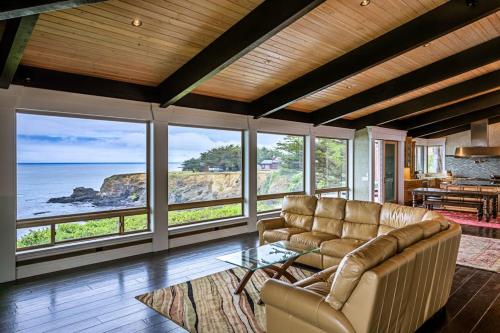 a living room with a couch and a view of the ocean at Oceanfront Dream Hideaway in Gualala