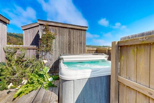 a hot tub sitting on a wooden fence at Blue Mermaid in Sea Ranch
