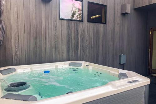 a jacuzzi tub in a room with blue water at Timber & Tide in Sea Ranch