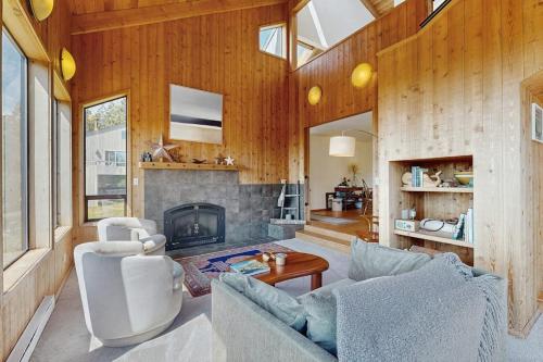 a living room with a couch and a fireplace at Timber & Tide in Sea Ranch