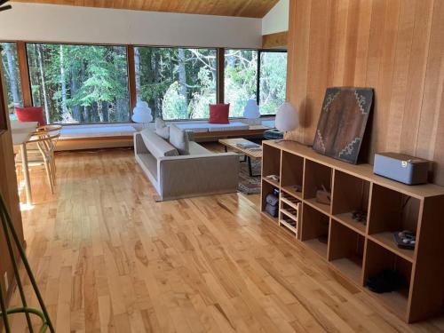 a living room with a couch and a television at Madrone Meadow in Sea Ranch