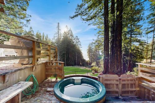 a hot tub in a yard next to a tree at Schooner in Sea Ranch