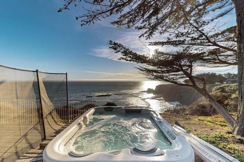 a bath tub sitting next to the ocean at Oceanfront Dream Hideaway and Retreat in Gualala