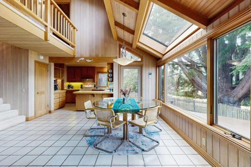 a dining room with a glass table in a kitchen at Cypress Cove in Sea Ranch