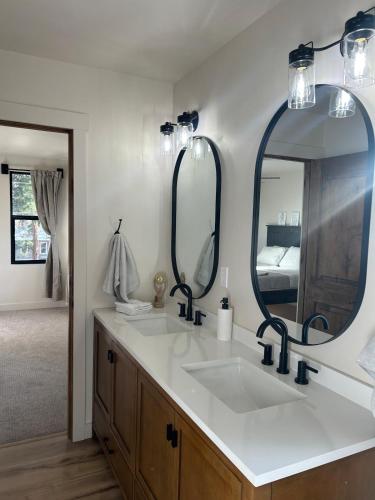 a bathroom with a sink and two mirrors at The Farmhouse in Darby
