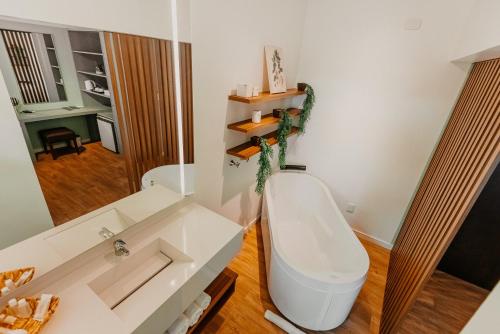 a bathroom with a white toilet and a mirror at Hotel Petrópolis in Nova Petrópolis