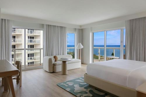 a hotel room with a bed and a view of the ocean at Fort Lauderdale Marriott Pompano Beach Resort in Pompano Beach