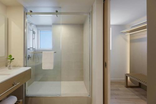 a glass shower in a bathroom with a sink at Fort Lauderdale Marriott Pompano Beach Resort in Pompano Beach