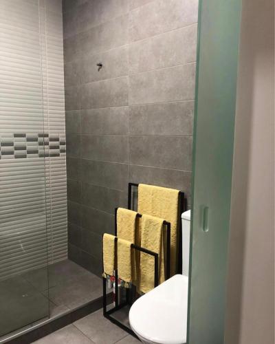a bathroom with a shower and a toilet and towels at Luxury House Cascais in Cascais