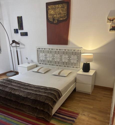 a bedroom with a large bed with two night stands at Luxury House Cascais in Cascais