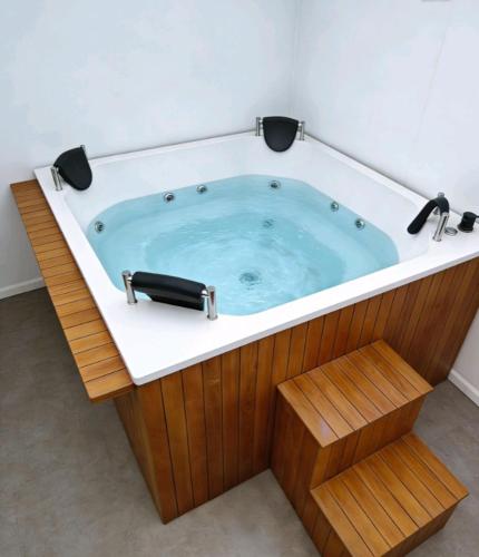 a jacuzzi tub in a room with a wooden at Room cerca al aeropuerto #1 in Bogotá