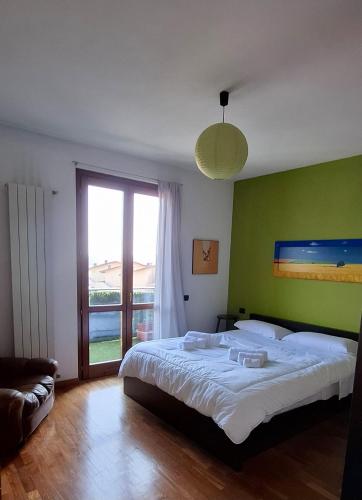 a bedroom with a large bed and a large window at La finestra sul lago in Clusane sul Lago