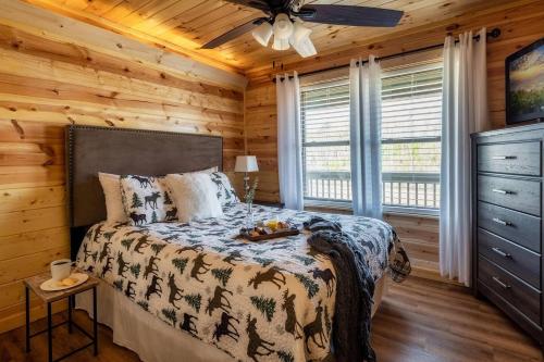 a bedroom with a bed in a log cabin at Firefly Cabin in Pigeon Forge