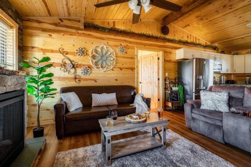 a living room with a couch and a table at Firefly Cabin in Pigeon Forge
