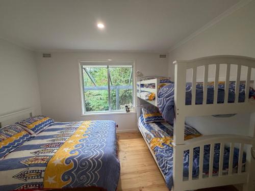 a bedroom with two bunk beds and a window at Ameys Ridge Stay 3 Pay 2 Winter Special in Foster