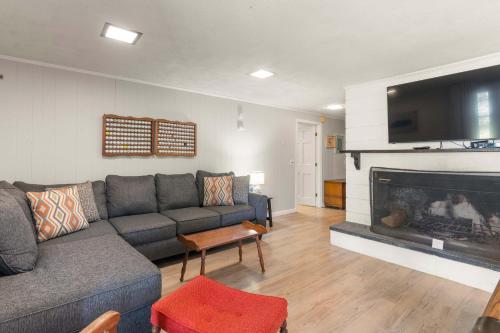 a living room with a couch and a fireplace at Central AC Game Room Dog-Friendly in Chatham